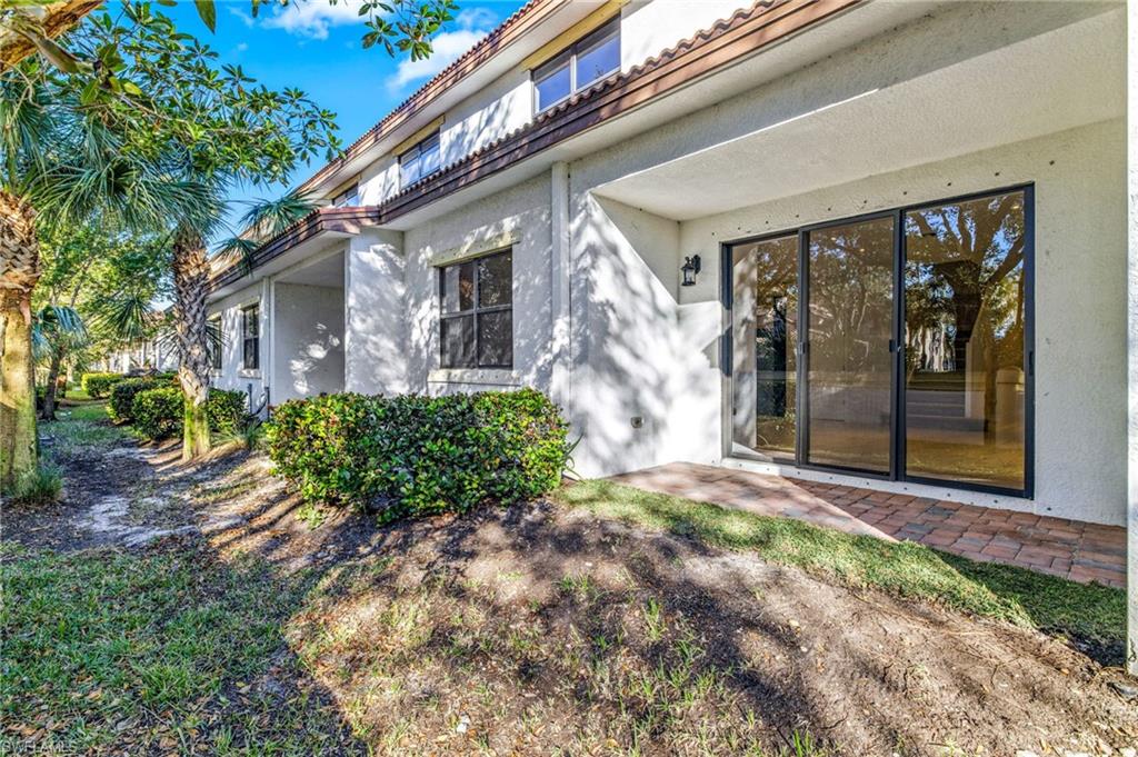 7841 Bristol Circle Naples, FL 34120 - Photo 22 of 28 a front view of a house with a yard