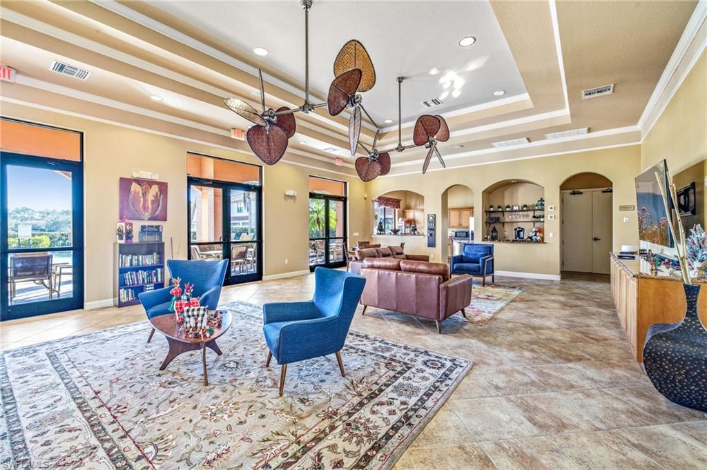 7841 Bristol Circle Naples, FL 34120 - Photo 27 of 28 a living room with fireplace furniture and a chandelier