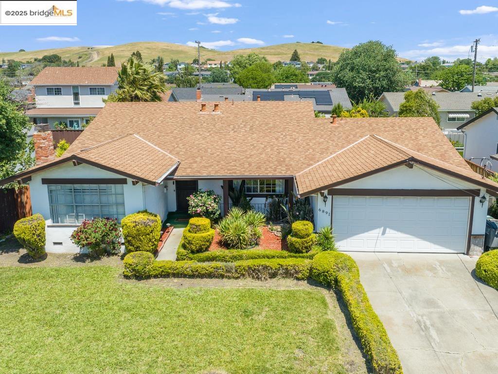 an aerial view of a house with a yard