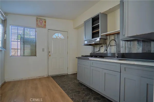 a kitchen with cabinets appliances and a window