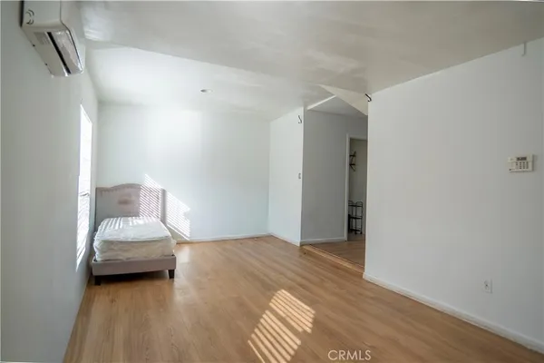 a bedroom with a bed and a mirror