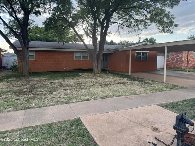 a view of a house with large trees