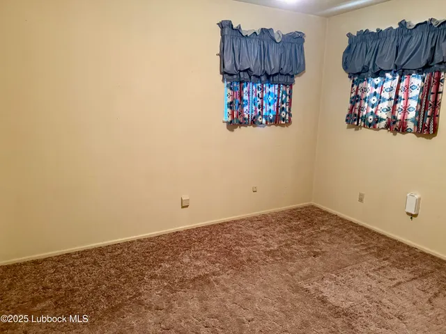 a view of a kitchen with furniture and wooden floor