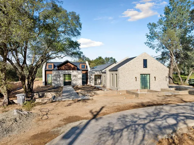 a view of a white house with a yard