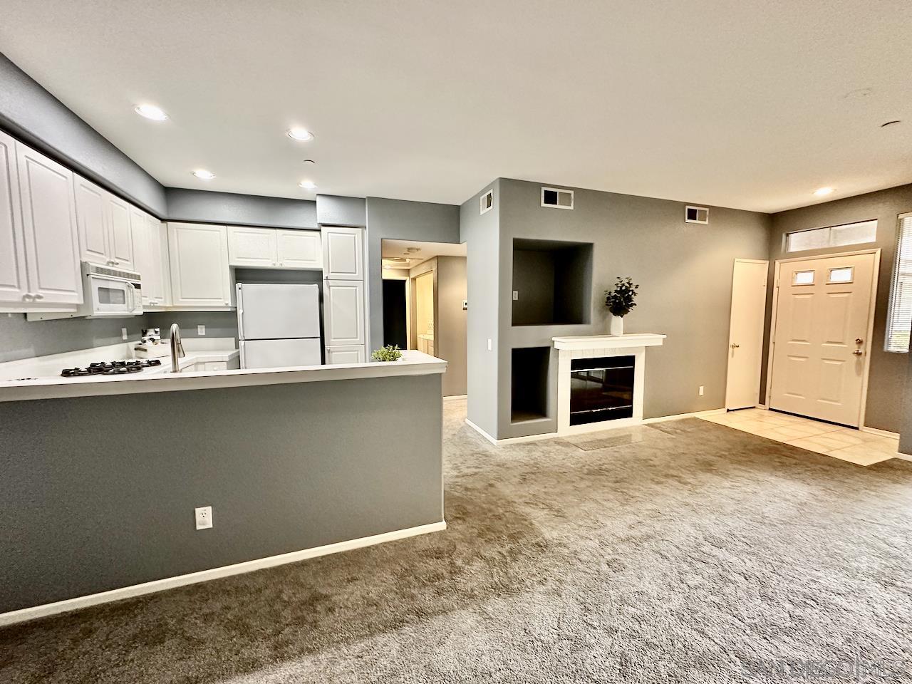 10766 Sabre Hill Drive, Unit 154 San Diego, CA 92128 - Photo 1 of 16 a view of kitchen with granite countertop stove top oven and cabinets