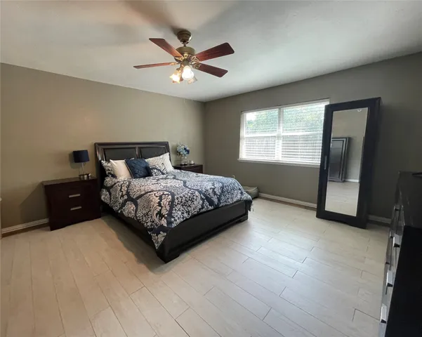 a bedroom with a bed lamp and window