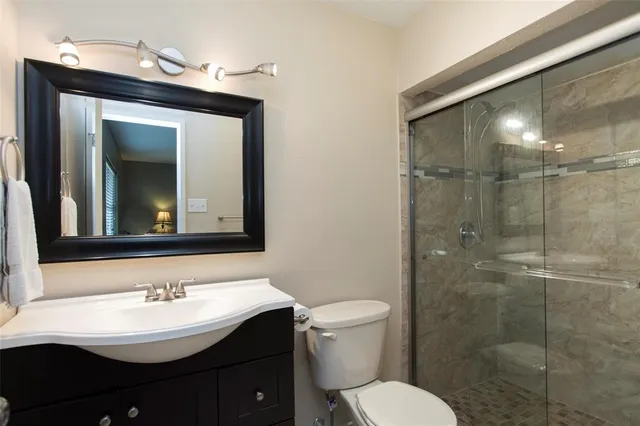 a bathroom with a sink toilet and shower