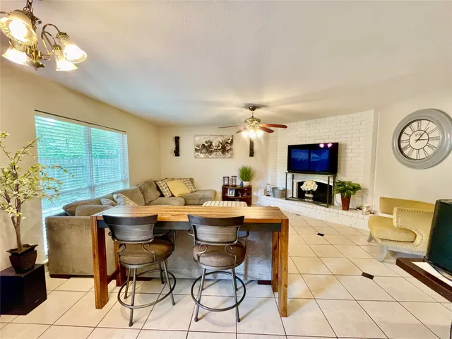 a living room with fireplace furniture and a flat screen tv