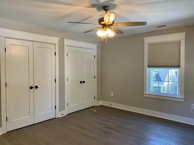 a view of a room with wooden floor and cabinet