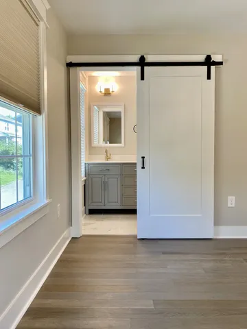a bathroom with a sink vanity and mirror