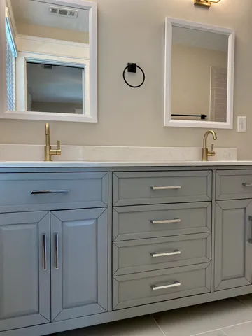 a bathroom with a granite countertop sink and a bathtub