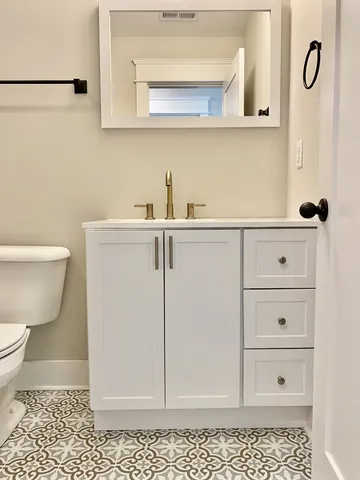 a bathroom with a toilet and a bath tub