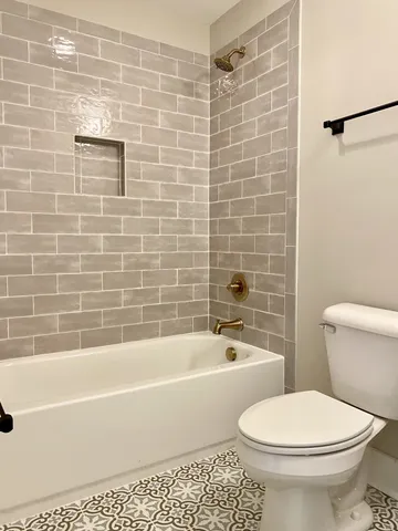 a kitchen with stainless steel appliances kitchen island granite countertop a stove a sink and a refrigerator