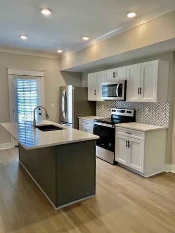 a kitchen with a refrigerator stove and sink