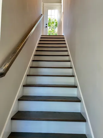 a view of a hallway with wooden floor and a hallway