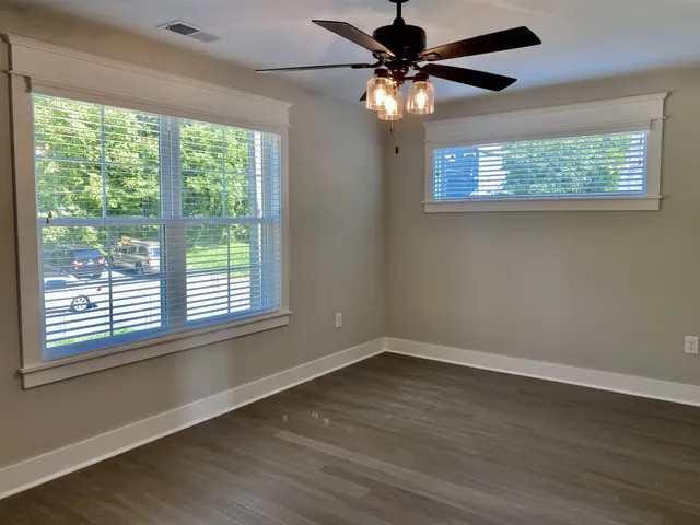 a view of an empty room with wooden floor