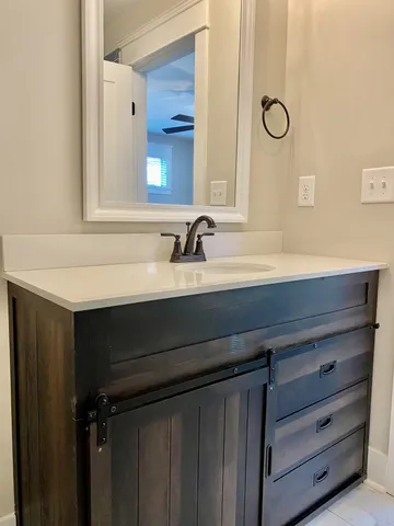 a bathroom with a sink a toilet and mirror