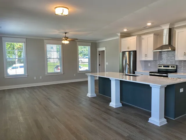 a kitchen with stainless steel appliances granite countertop a stove a sink and a refrigerator