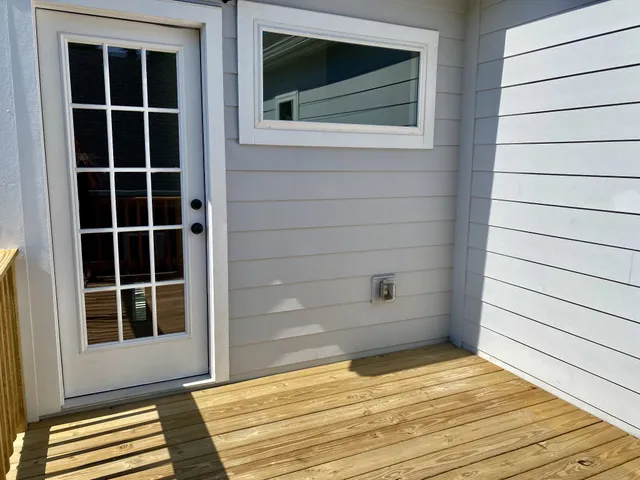 a balcony with wooden floor and fence