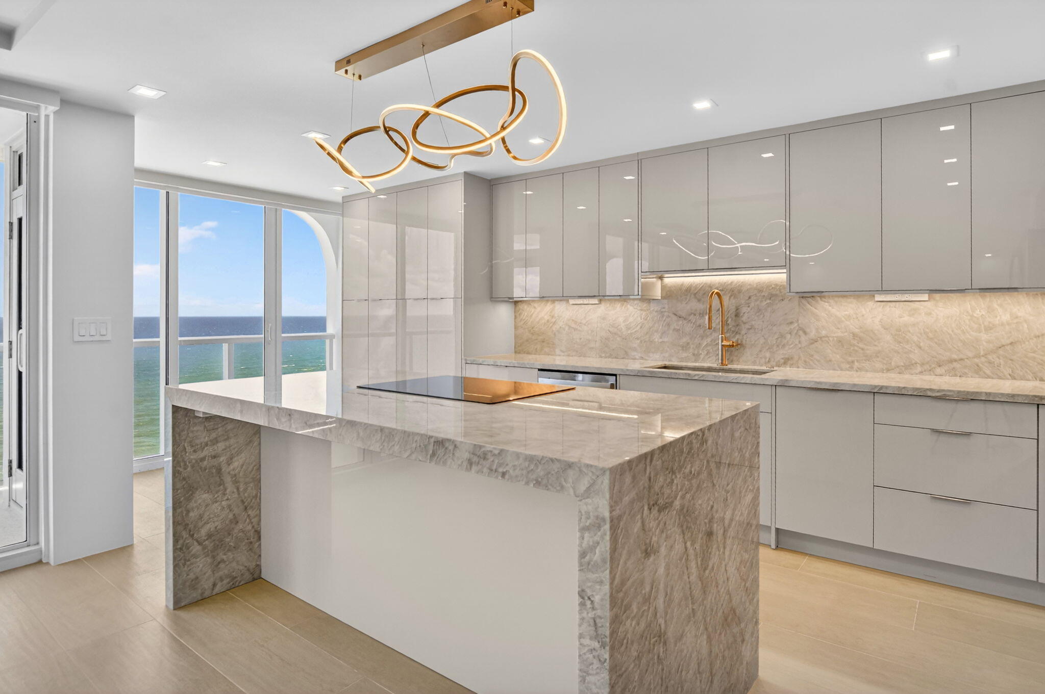 2800 South Ocean Boulevard, Unit 23C Boca Raton, FL 33432 - Photo 12 of 50 a kitchen with kitchen island granite countertop a sink a counter space and cabinets