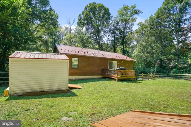 a view of a backyard with a small cabin