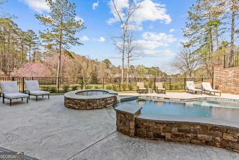 a view of a house with backyard and sitting area