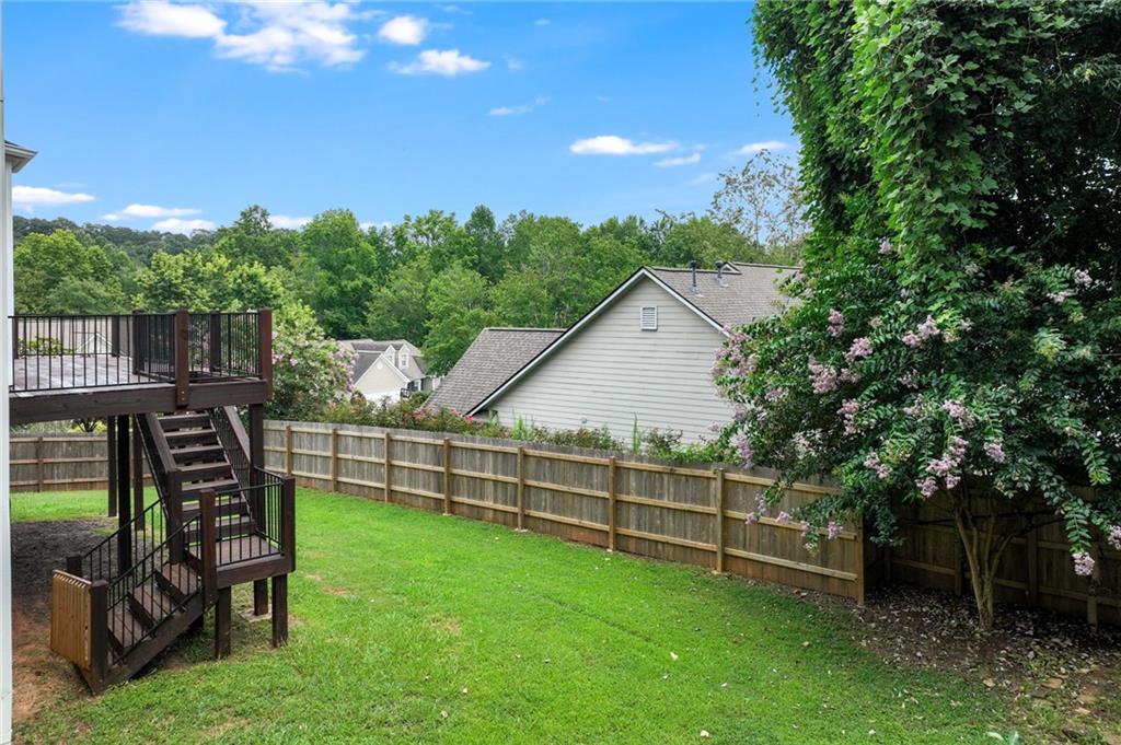 3903 Walnut Grove Way Gainesville, GA 30506 - Photo 12 of 48 a view of a backyard with a garden and entertaining space