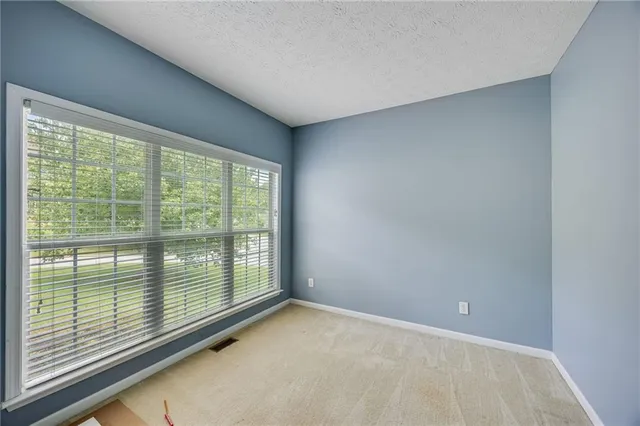 a view of an empty room with a large window