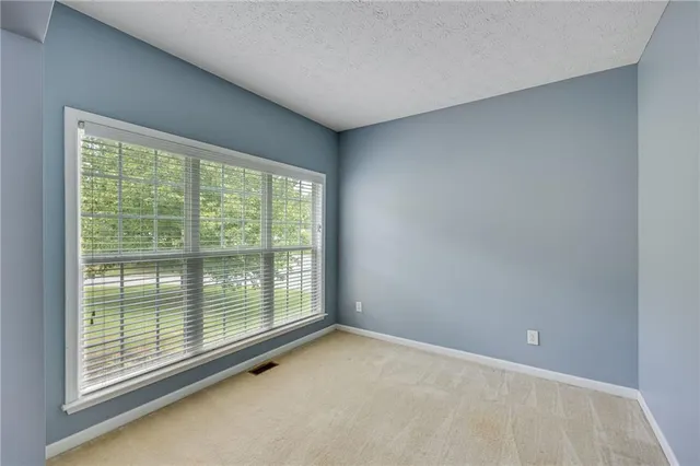a view of an empty room with a balcony