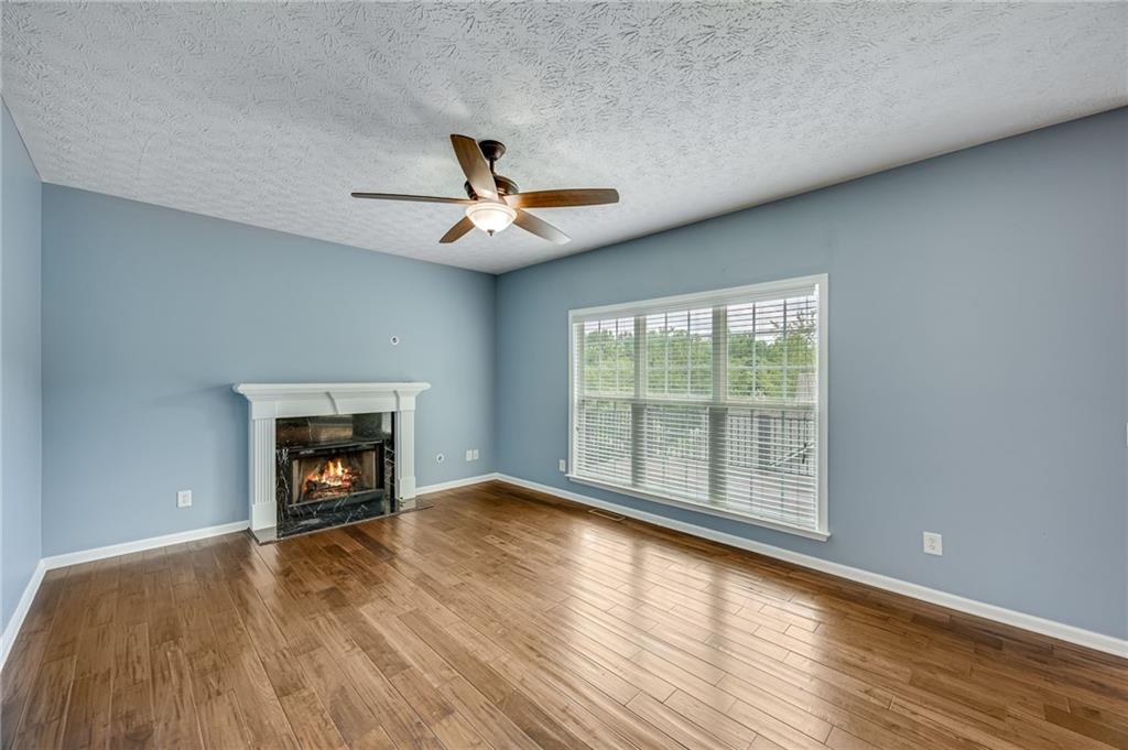 3903 Walnut Grove Way Gainesville, GA 30506 - Photo 19 of 48 a view of empty room with wooden floor and fireplace