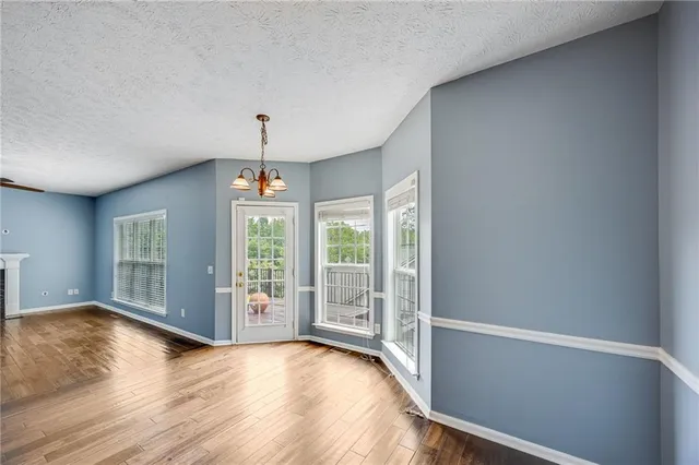 a view of an empty room with glass door and balcony