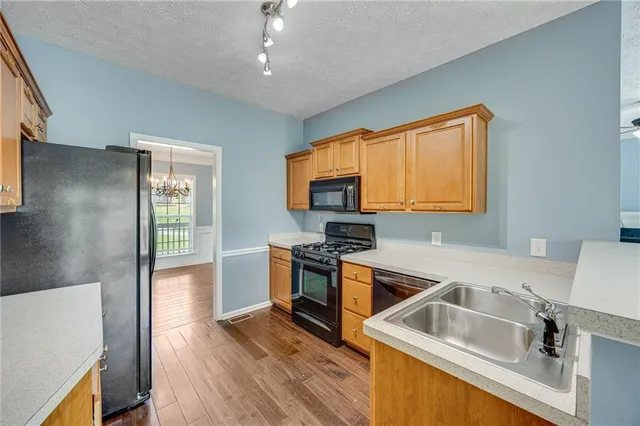 a kitchen that has a sink and a stove top oven