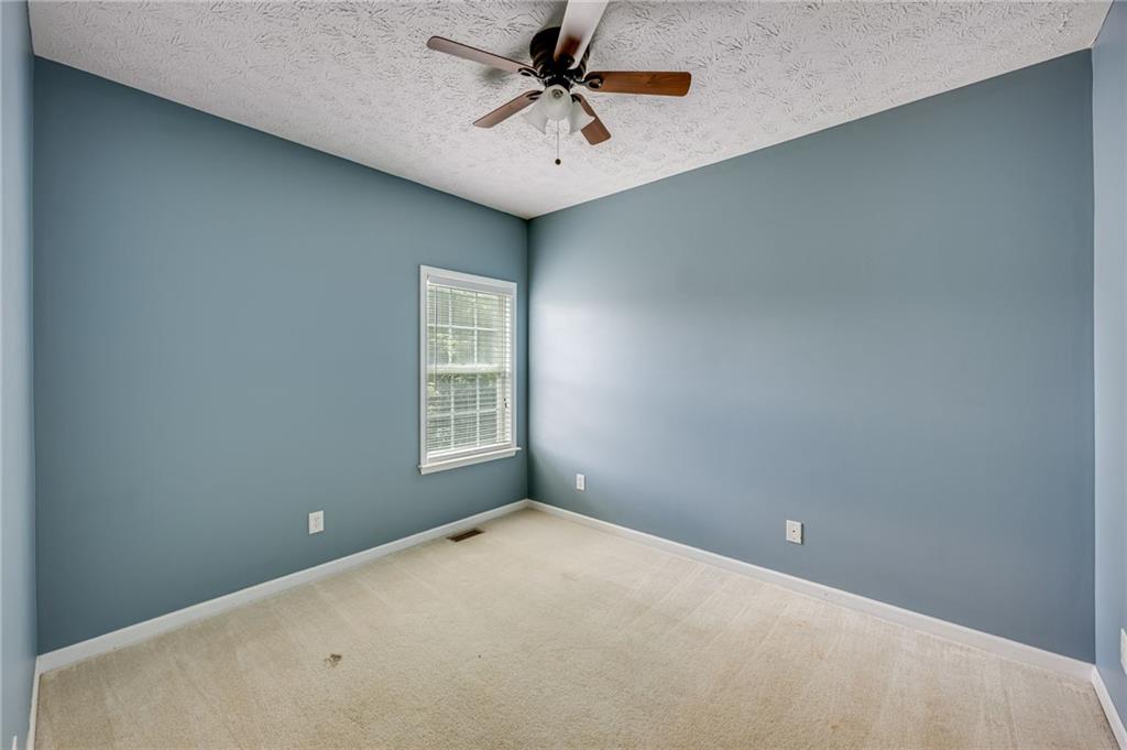 3903 Walnut Grove Way Gainesville, GA 30506 - Photo 26 of 48 an empty room with a ceiling fan and window