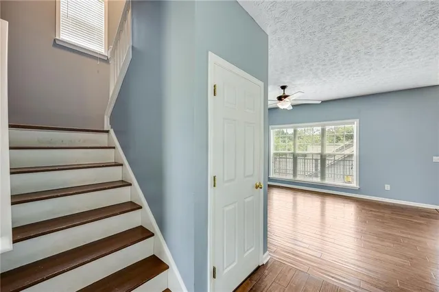 a view of an entryway with wooden floor and staircase