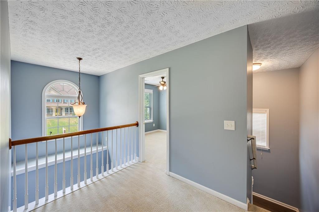 3903 Walnut Grove Way Gainesville, GA 30506 - Photo 32 of 48 a view of a hallway with windows and chandelier
