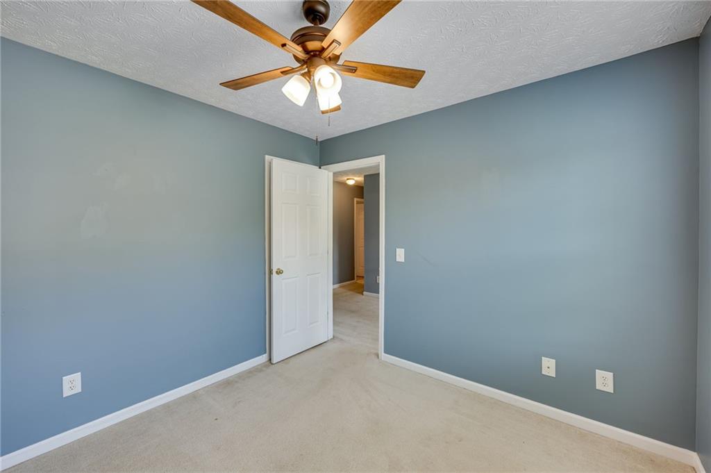 3903 Walnut Grove Way Gainesville, GA 30506 - Photo 34 of 48 an empty room with a chandelier fan and a chandelier fan