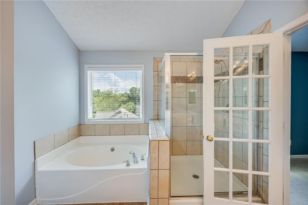 3903 Walnut Grove Way Gainesville, GA 30506 - Photo 44 of 48 a bathroom with a bathtub and shower