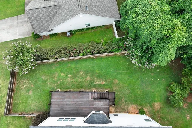 a wooden bench sitting in the middle of a yard
