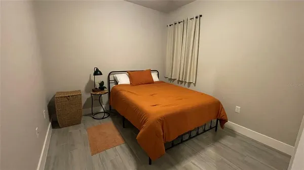 a bed sitting in a bedroom next to a window
