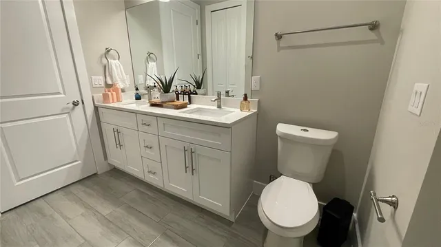 a bathroom with a toilet sink and mirror