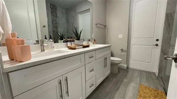 a bathroom with a double vanity sink and mirror