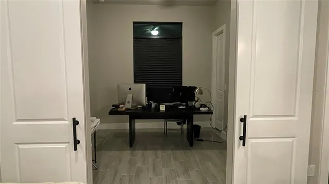 a view of a bedroom with table and chair