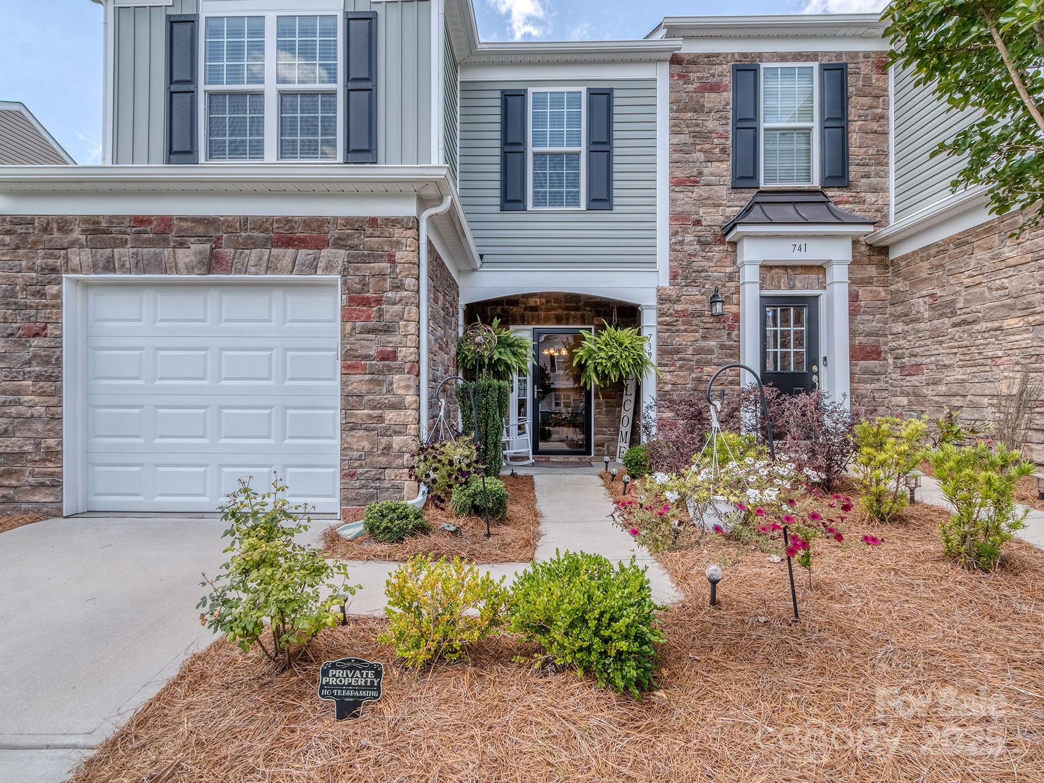 front view of a brick house with a yard