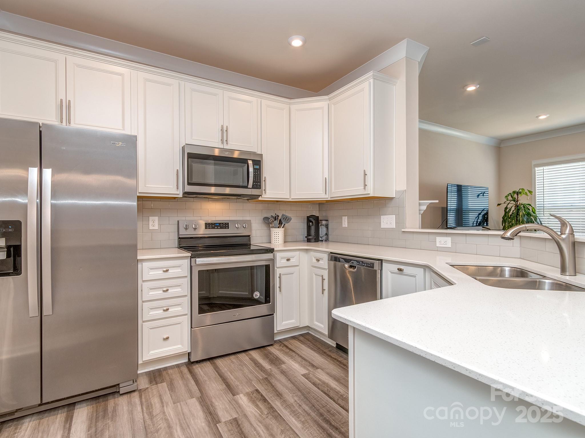 739 Elders Story Road Fort Mill, SC 29708 - Photo 4 of 30 a kitchen with a sink a microwave a refrigerator and cabinets