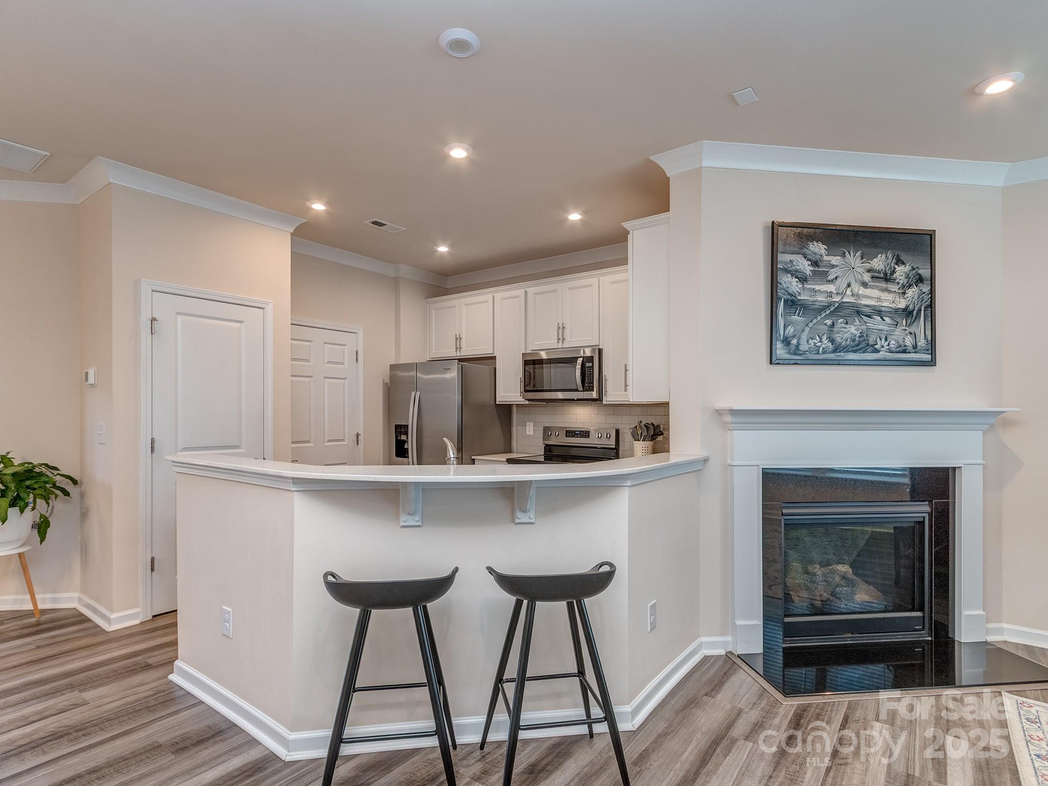 739 Elders Story Road Fort Mill, SC 29708 - Photo 10 of 30 a living room with stainless steel appliances furniture a fireplace and wooden floor
