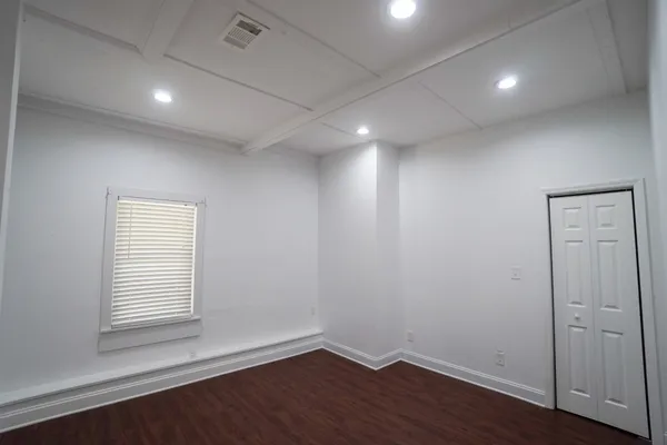 a view of an empty room and wooden floor