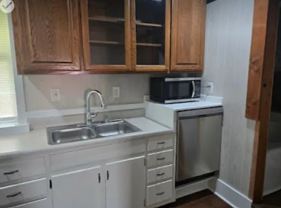 a kitchen with granite countertop cabinets appliances and a window