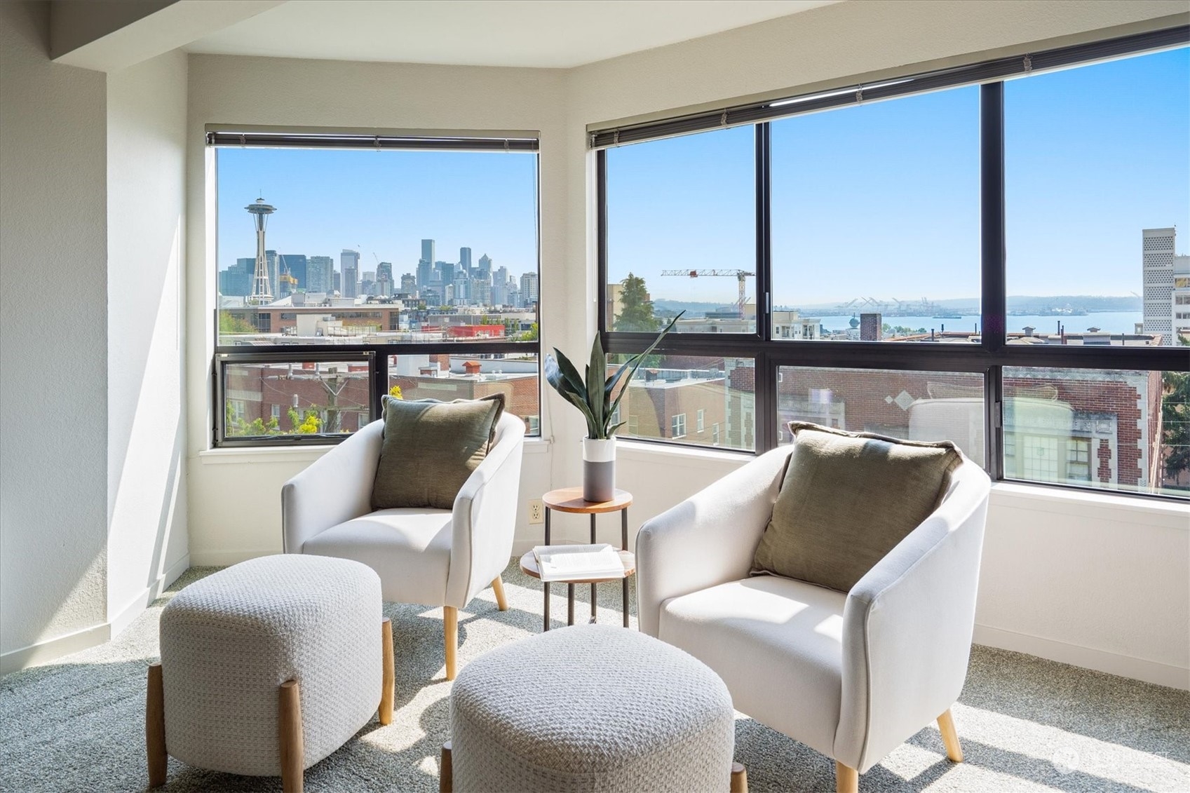 a living room with furniture city view and large windows