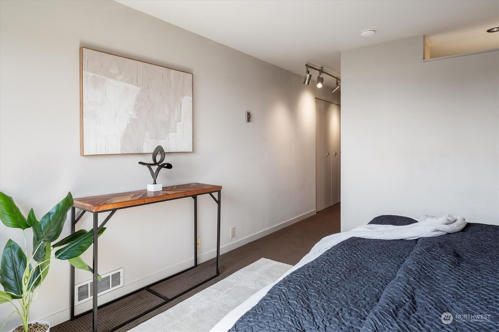 410 West Roy Street, Unit E305 Seattle, WA 98119 - Photo 18 of 31 a bedroom with a bed and a potted plant