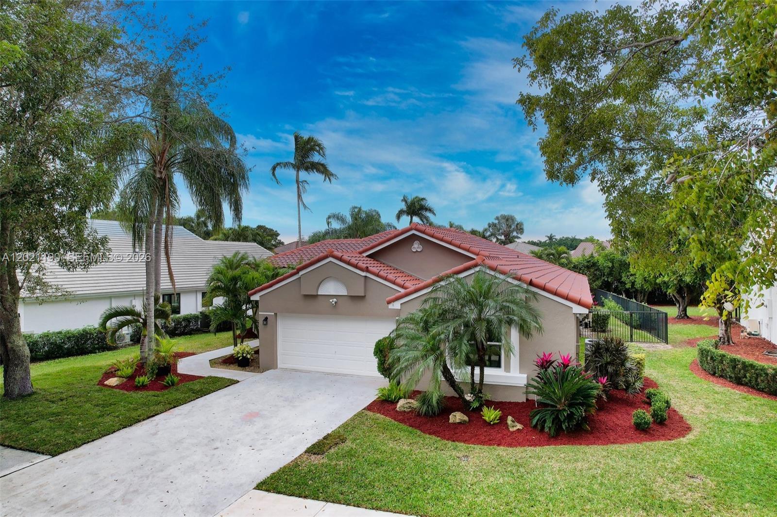 814 Heron Road Weston, FL 33326 - Photo 6 of 27 a view of a house with a yard and tree s